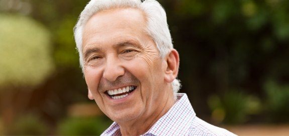Man sharing smile after dental implant tooth replacement
