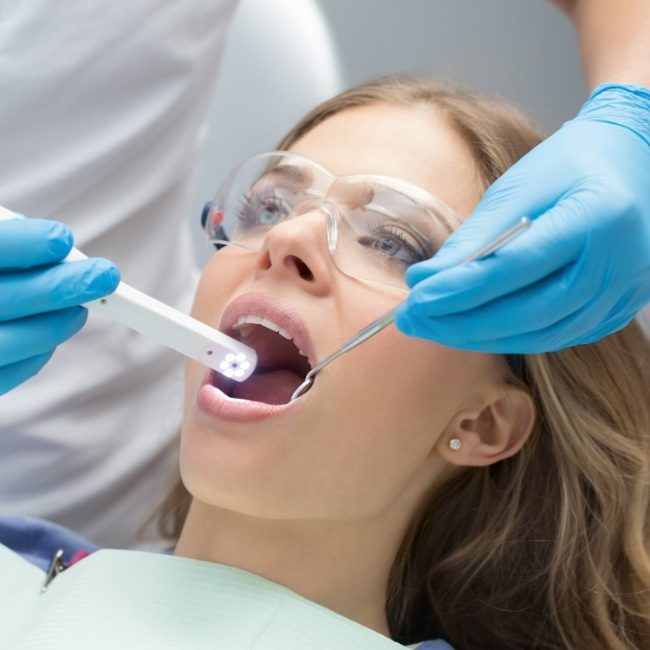 Oral surgeon capturing bite impressions using intraoral digital scanner