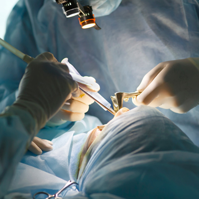 Oral surgeon carefully working on a patient