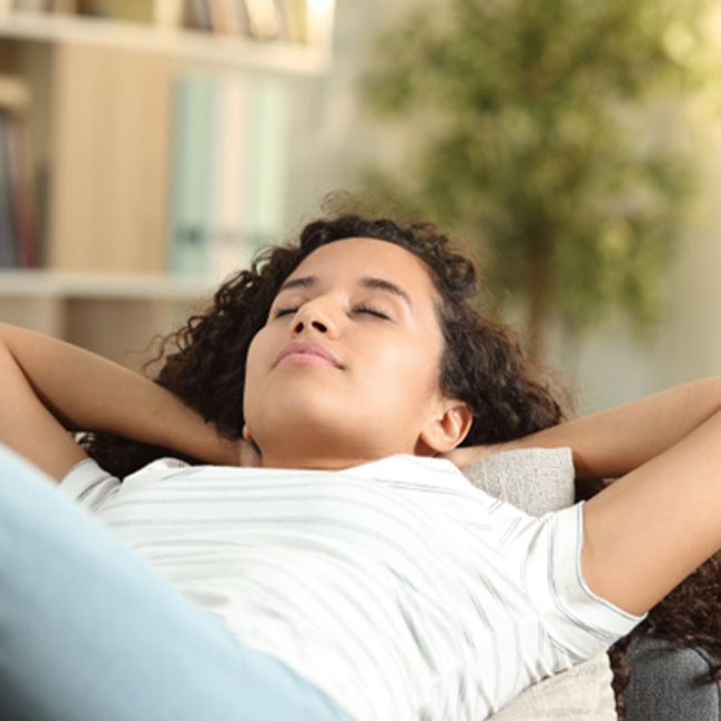 Woman resting on her sofa at home