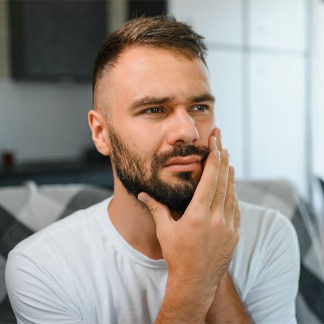 Concerned man touching his face