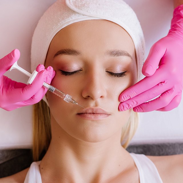 Woman receiving dermal fillers in Katy near her mouth