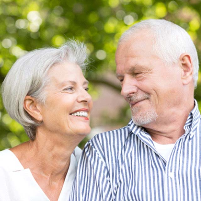 Woman with implant dentures smiling at her husband