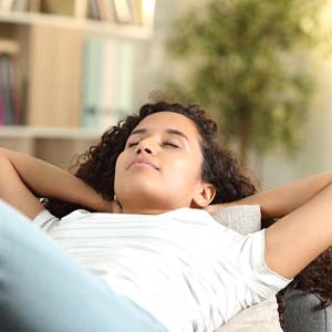 Woman resting at home after dental implant surgery