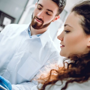 Oral surgeon and patient discussing how dental implants work in Katy