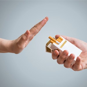 Hand extended to decline the offer of a cigarette