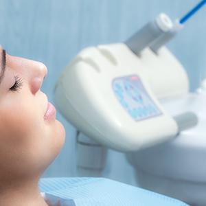 Dental patient with eyes closed, relaxing under influence of sedation