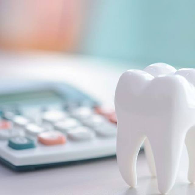 Calculator next to tooth model