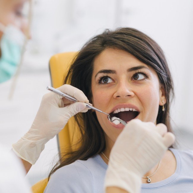 Patient receiving oral surgery under local anesthesia