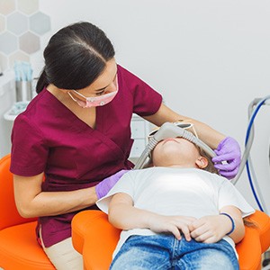 Young dental patient being fitted for nitrous oxide mask