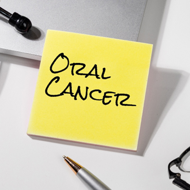 Yellow sticky note with “oral cancer” written on it