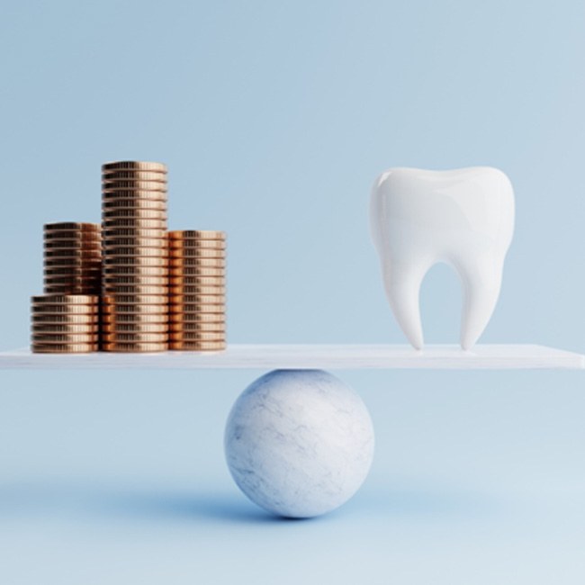 Tooth model balanced against stack of coins