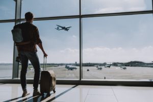 Man at airport, preparing to fly after a tooth extraction