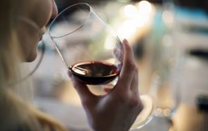 Woman enjoying alcoholic beverage after recovering from a tooth extraction