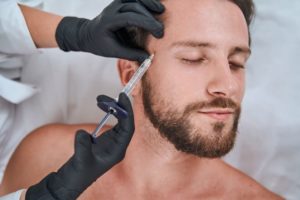 Man relaxing while receiving dermal filler injection