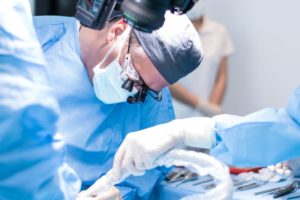Oral surgery team carefully performing procedure