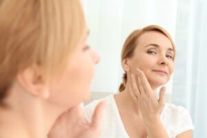 Mature woman looking at herself in the mirror