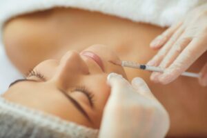 Woman receiving cosmetic injection in her lip