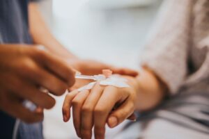 Patient getting IV placed in her hand