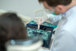 Patient and oral surgeon reviewing X-ray together