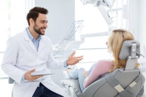 Dentist and patient having relaxed conversation 