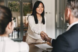 Man and woman shaking hands during business meeting 