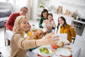 Happy family taking a selfie during a special meal 