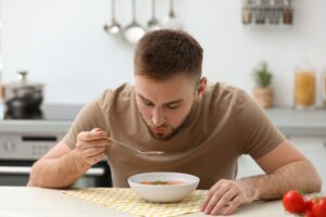 Man enjoying a tasty bowl of soup 