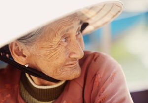 Older woman who is experiencing facial collapse due to tooth loss 