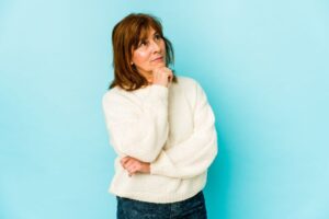 Senior woman wearing thoughtful, contemplative expression