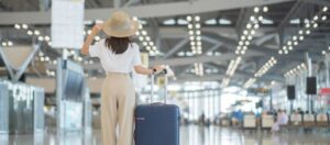 Woman standing with her suitcase in airport