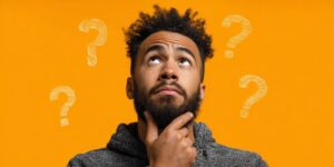 Man touching his chin while question marks float around him