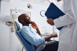 Oral surgeon answering patient’s questions during consultation 