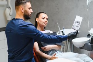 Patient having serious conversation with her oral surgeon
